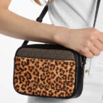 A Person Holding Michael Kors Jet Set Travel Leopard Print Camera Crossbody Bag