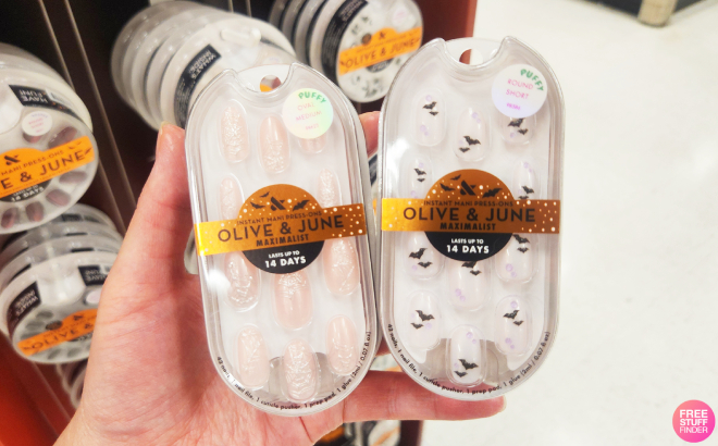 A Person Holding Olive June Puffy Bats and Candy Chrome SpiderwebsPress On Fake Nails
