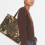 A Person Holding Tory Burch Ella Printed Nylon Small Tote