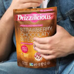A Person Holding the Drizzilicious Strawberry Chocolaty Bites Mini Rice Cakes 4 OZ