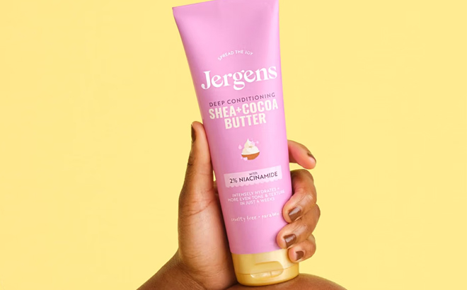 A Person Holding the Jergens Shea Cocoa Hand Body Lotion For Dry Skin