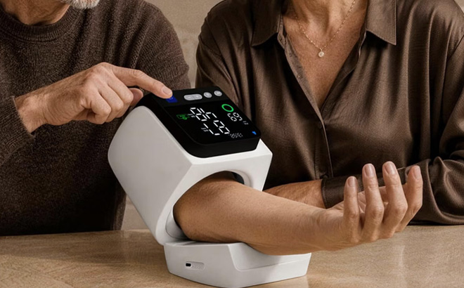 A Person Using Automatic Blood Pressure Monitor