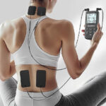 A Person Using Tens Unit Muscle Simulator for Pain Relief