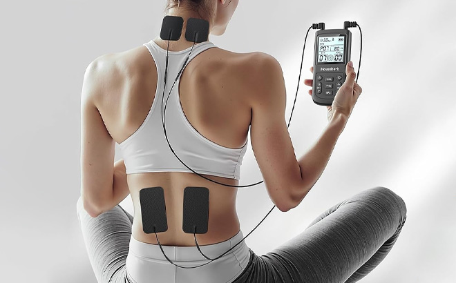 A Person Using Tens Unit Muscle Simulator for Pain Relief