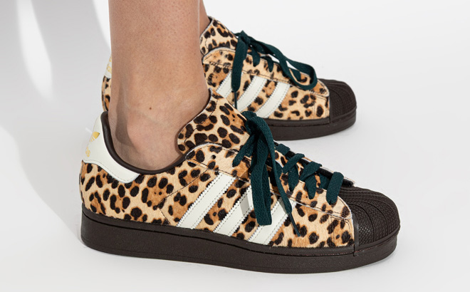 A Person Wearing Adidas Womens Superstar II Athletic Shoes