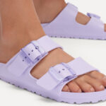 A Person Wearing Birkenstock Arizona Stealth Buckle EVA Sandals in Purple Fog