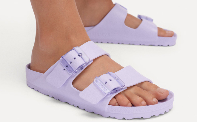 A Person Wearing Birkenstock Arizona Stealth Buckle EVA Sandals in Purple Fog