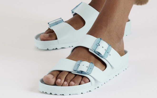 A Person Wearing Birkenstock Arizona Stealth Buckle EVA Sandals in Surf Green