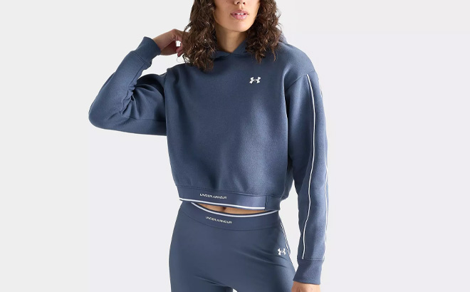 A Person Wearing Under Armour Womens Piping Cropped Pullover Hoodie