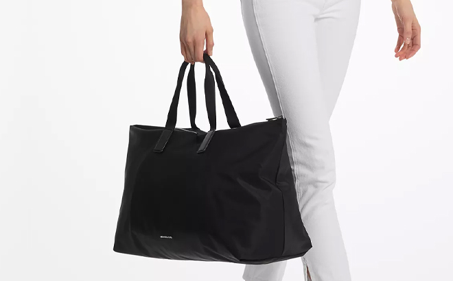 A Woman Holding Michael Kors Tanner Extra Large Reversible Packable Tote Handbag A Woman Holding Michael Kors Tanner Extra Large Reversible Packable Tote Handbag