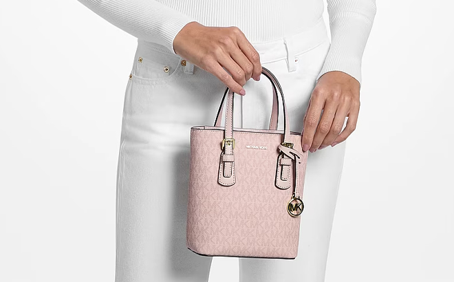 A Woman Holding Michael Kors Voyager Extra Small Signature Logo Convertible Crossbody Bag A Woman Holding Michael Kors Voyager Extra Small Signature Logo Convertible Crossbody Bag