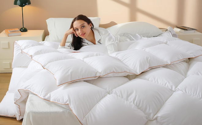 A Woman Laying on the Vexino Feather Down Fiber Comforter
