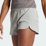 A Woman Wearing Adidas Pacer Training 3 Stripes Woven High Rise Shorts