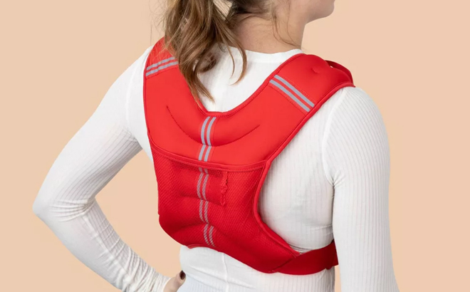 A Woman Wearing Blogilates Weighted Body Vest in Red A Woman Wearing Blogilates Weighted Body Vest in Red