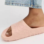 A Woman Wearing Coach Outlet Bay Slide In Signature