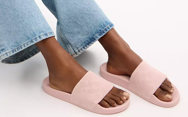 A Woman Wearing Coach Outlet Udele Sport Slides In Signature Denim