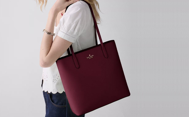 A Woman Wearing Kate Spade Jana Tote Bag in Grenache A Woman Wearing Kate Spade Jana Tote Bag in Grenache