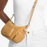 A Woman Wearing Michael Kors Merritt Small Signature Logo Convertible Shoulder Bag