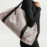 A Woman Wearing Nike Training Duffel Bag in Cream