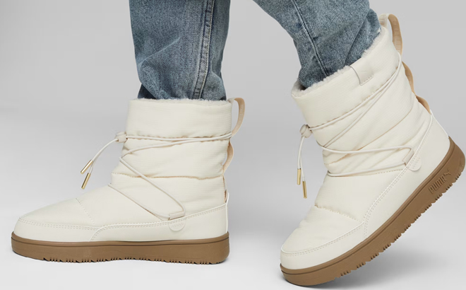 A Woman Wearing Puma Snowbae Boots A Woman Wearing Puma Snowbae Boots