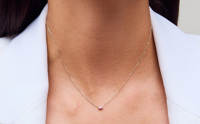 A Woman Wearing Zales Baguette Cut Pink Sapphire Solitaire Necklace in 10K Gold