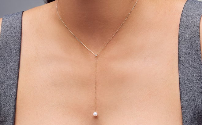 A Woman Wearing Zales Freshwater Cultured Pearl and Lab Grown Diamond Accent Y Necklace in 10K Gold