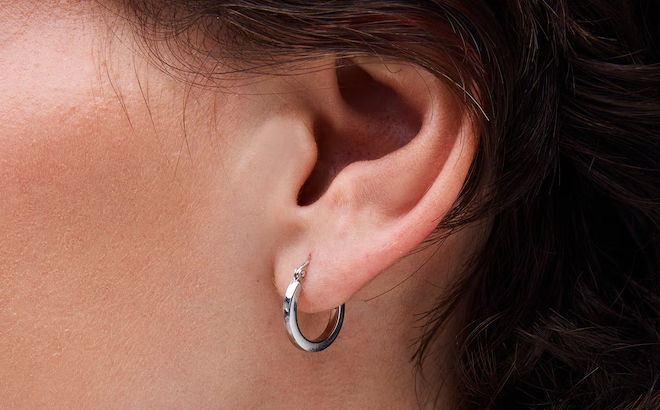 A Woman Wearing Zales Square Tube Hoop Earrings in Sterling Silver
