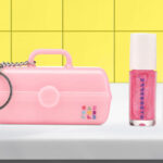 Caboodles Mini On The Go Girl Keychain with Lip Gloss on the Table