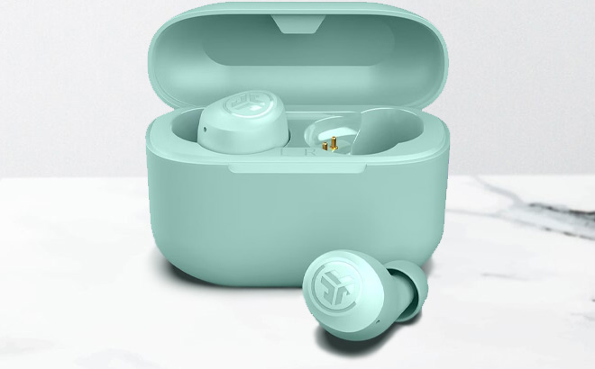 JLab Go Air Pop True Wireless Earbuds in Mint on the Table JLab Go Air Pop True Wireless Earbuds in Mint on the Table