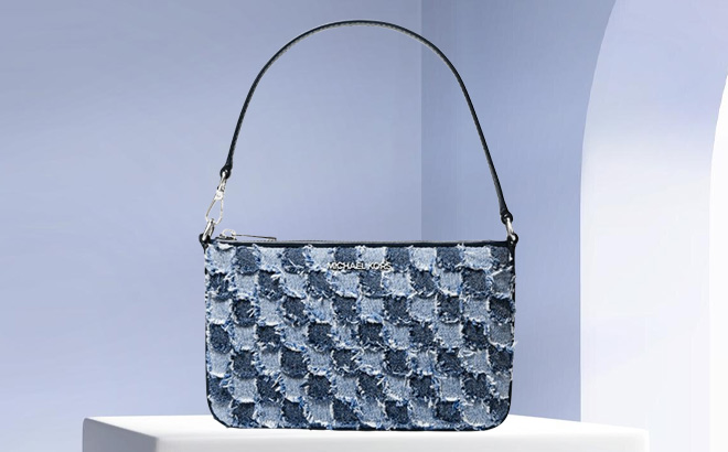 Michael Kors Jet Set Travel Small Patchwork Denim Convertible Wristlet on the Table Michael Kors Jet Set Travel Small Patchwork Denim Convertible Wristlet on the Table