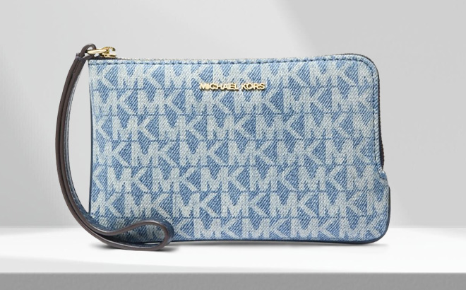 Michael Kors Jet Set Travel Small Signature Logo Print Denim Wristlet on the Table