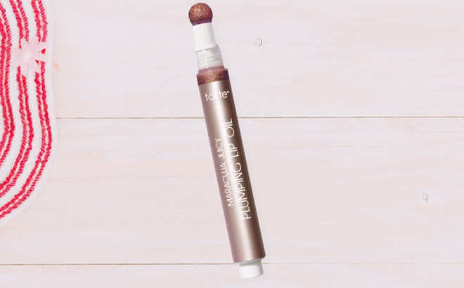 Tarte Maracuja Juicy Plumping Lip Oil on the Table