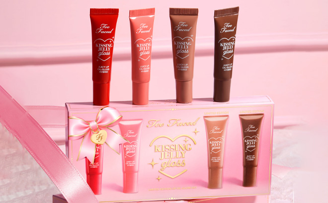 Too Faced 4 Piece Kissing Jelly Lip Oil Gloss Collection Set on the Table