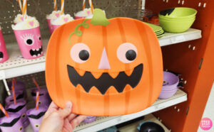 a Person Holdin Pillowfort Pumpkin Figural Plate