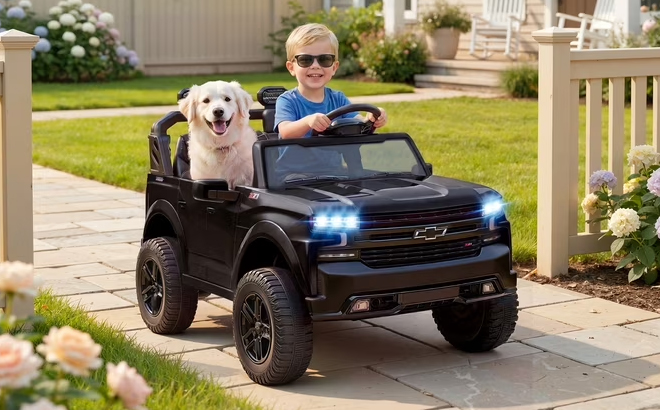 A Boy with a Dog Riding the Chevrolet Silverado Powered Ride on Truck A Boy with a Dog Riding the Chevrolet Silverado Powered Ride on Truck