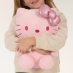 A Kid Holding Hello Kitty Kids Glow in the Dark Plush Cuddle Pillow Buddy