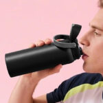 A Man Drinking from the Powcan 24 Ounce Insulated Water Bottle