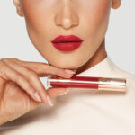 A Person Holding Charlotte Tilbury Airbrush Flawless Lip Blur in Ruby Blur Shade