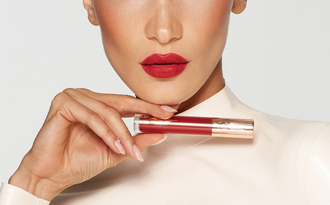 A Person Holding Charlotte Tilbury Airbrush Flawless Lip Blur in Ruby Blur Shade