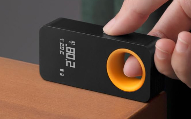A Person Holding HOTO Pocket Size Laser Measuring Tool A Person Holding HOTO Pocket Size Laser Measuring Tool