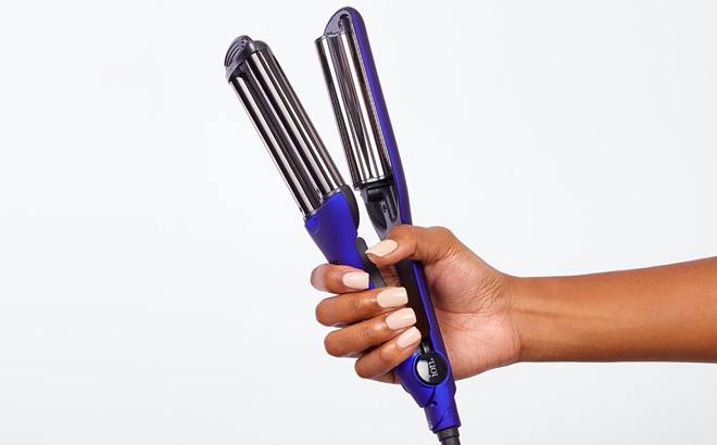 A Person Holding ION Titanium Pro Triple Barrel Waver A Person Holding ION Titanium Pro Triple Barrel Waver