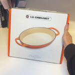A Person Holding Le Creuset 1 Qt Enameled Cast Iron Oval Baker