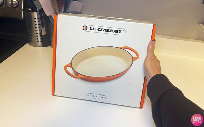 A Person Holding Le Creuset 1 Qt Enameled Cast Iron Oval Baker