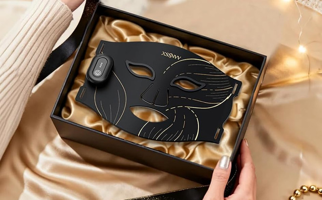 A Person Holding Red Light Therapy Mask A Person Holding Red Light Therapy Mask