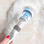 A Person Holding Tzumi Evo Scrub It Electric Cordless Spin Scrubber