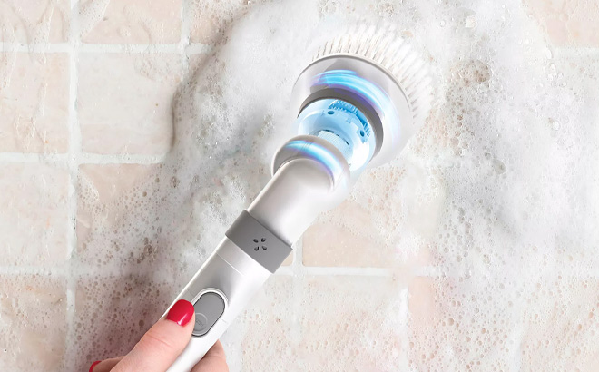 A Person Holding Tzumi Evo Scrub It Electric Cordless Spin Scrubber