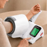 A Person Using Blood Pressure Monitor