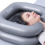 A Person Using Inflatable Shampoo Basin in Gray Color