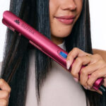 A Person Using Sutra Beauty 1 Inch Digital Flat Iron