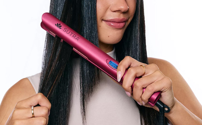 A Person Using Sutra Beauty 1 Inch Digital Flat Iron